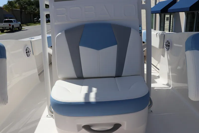 Slide: The Image of 2024 Robalo R202 EX boat seat with blue and white upholstery. - 12