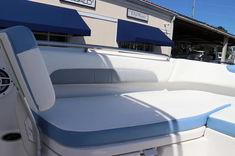 Slide: The Image of 2024 Robalo R202 EX boat with white and blue cushioned seating. - 13