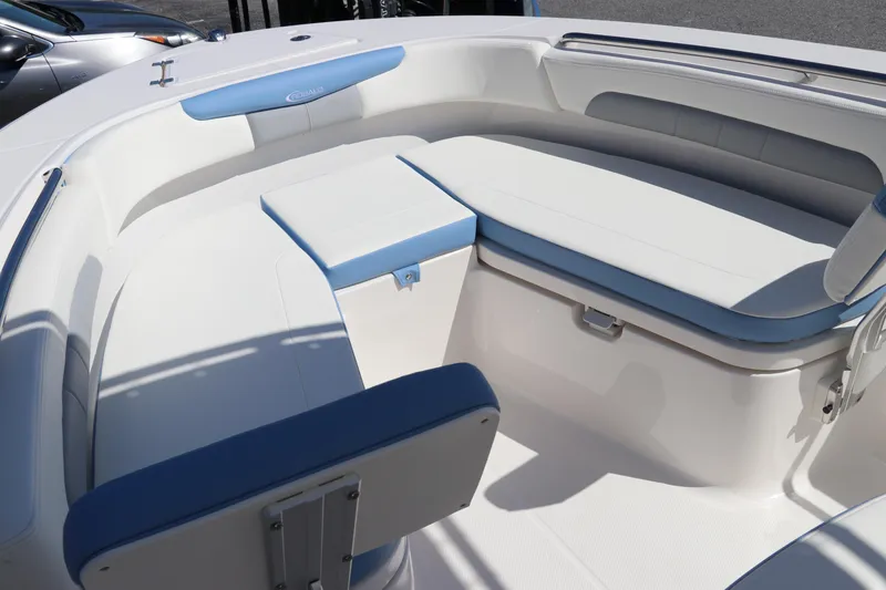 Slide: The Image of 2024 Robalo R202 EX boat interior with white and blue seating. - 16