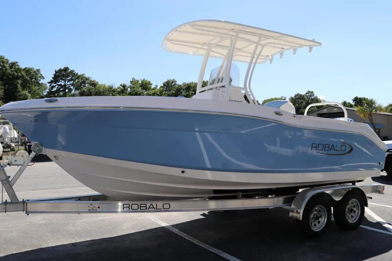 Slide: The Image of 2024 Robalo R202 EX boat on a trailer in a parking lot. - 4