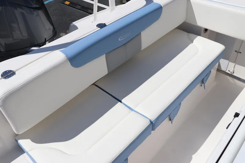 Slide: The Image of 2024 Robalo R202 EX boat seating area with white and blue cushions. - 8