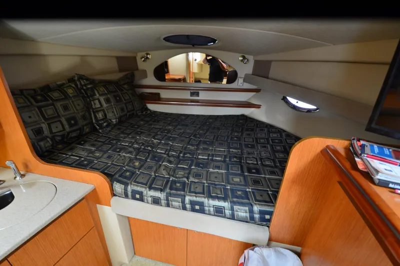 Slide: The Image of Luxurious cabin interior of 2004 Cruisers Yachts 320 Express with patterned bedding. - 14