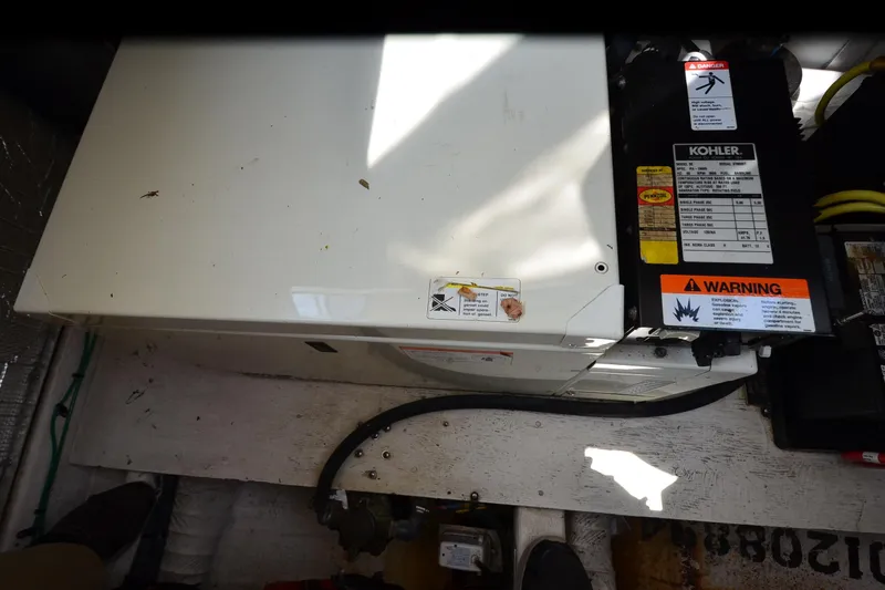 Slide: The Image of Engine compartment of a 2004 Cruisers Yachts 320 Express with Kohler generator. - 25