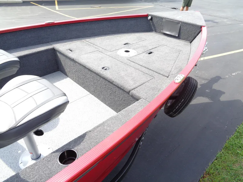 Slide: The Image of 2024 Lund 1650 Angler boat interior with seating and storage compartments. - 6