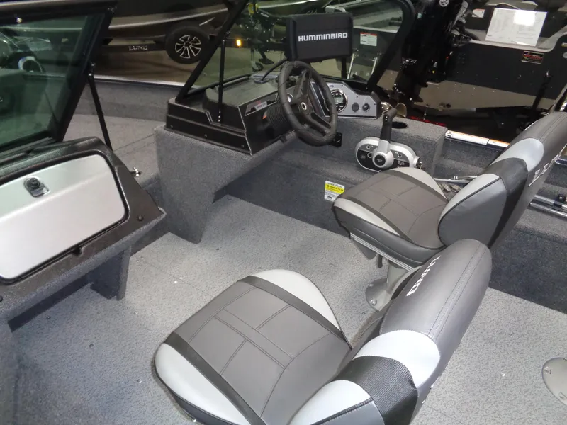 Slide: The Image of 2024 Lund 1650 Angler Sport interior with steering wheel and seating. - 4