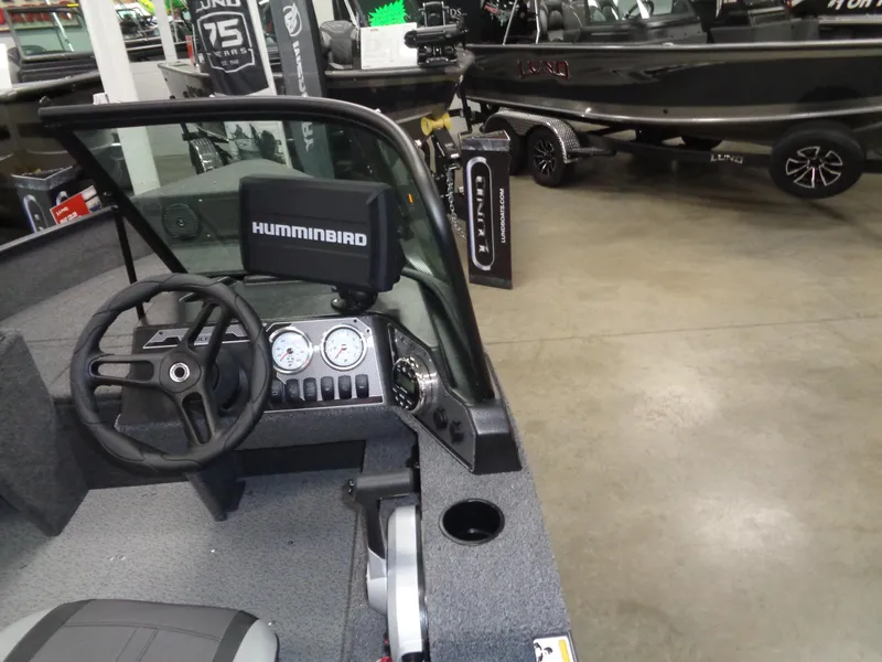Slide: The Image of 2024 Lund 1650 Angler Sport boat interior with steering wheel and Humminbird display. - 5