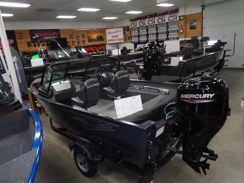 Slide: The Image of 2024 Lund 1650 Angler Sport boat with Mercury engine in showroom display. - 6