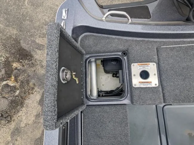 Slide: The Image of Open storage compartment on a 2025 Lund 219 Pro-V GL boat. - 11