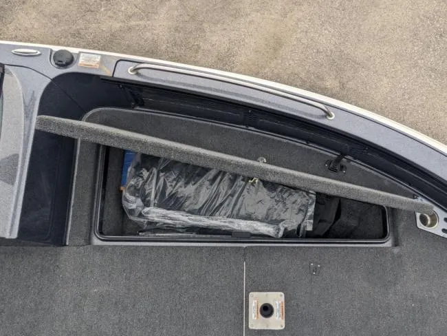 Slide: The Image of 2025 Lund 219 Pro-V GL boat storage compartment with cover. - 7