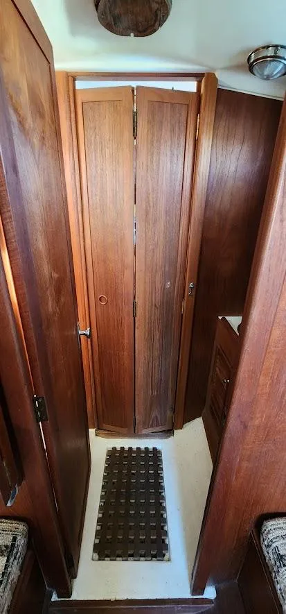 Slide: The Image of 1980 Cape Dory 30 interior with wooden cabinetry and flooring. - 11