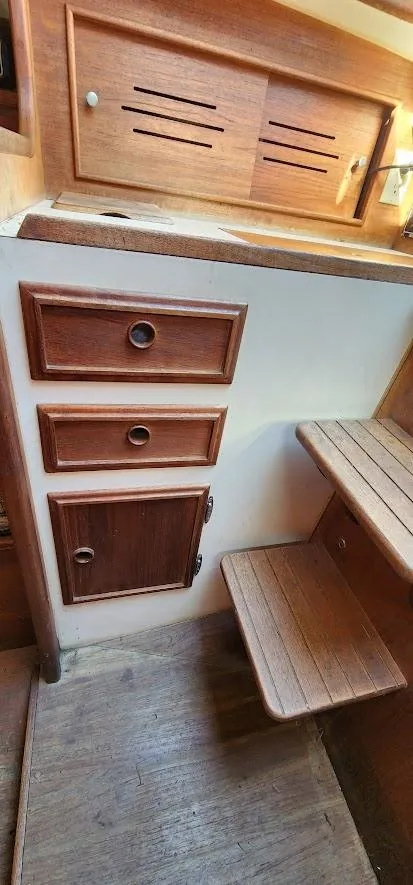 Slide: The Image of Interior of 1980 Cape Dory 30 sailboat with wooden cabinetry and steps. - 16