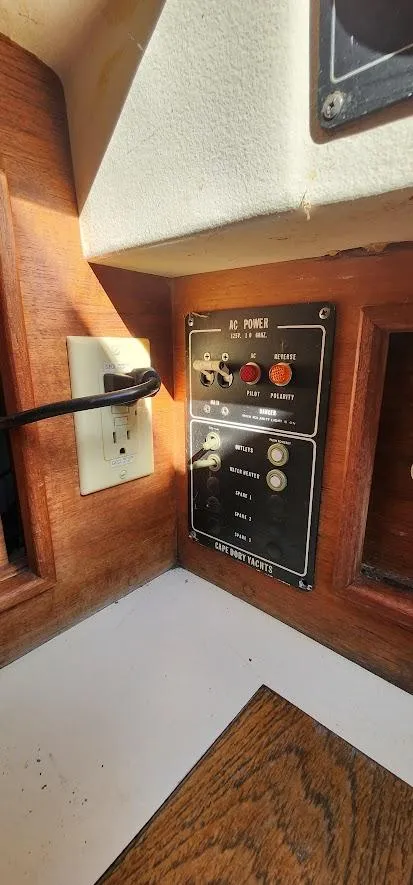 Slide: The Image of Control panel of a 1980 Cape Dory 30 sailboat with switches and outlets. - 18