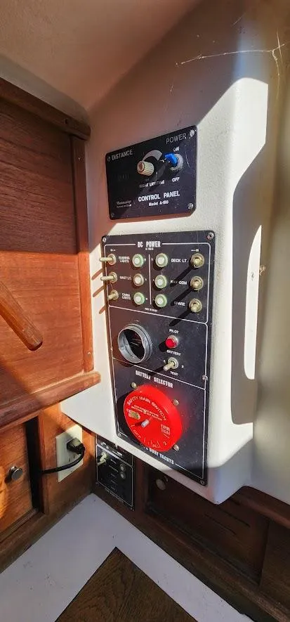 Slide: The Image of Control panel of a 1980 Cape Dory 30 sailboat, featuring switches and gauges. - 19