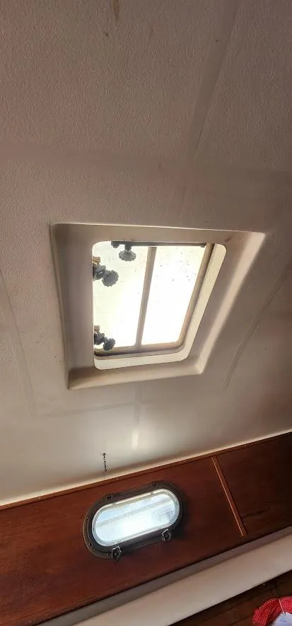 Slide: The Image of Interior view of a 1980 Cape Dory 30 sailboat with a ceiling hatch. - 22