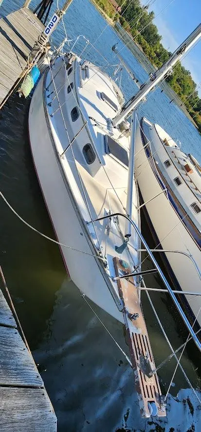 Slide: The Image of 1980 Cape Dory 30 sailboat docked on a sunny day, showcasing classic design and craftsmanship. - 26