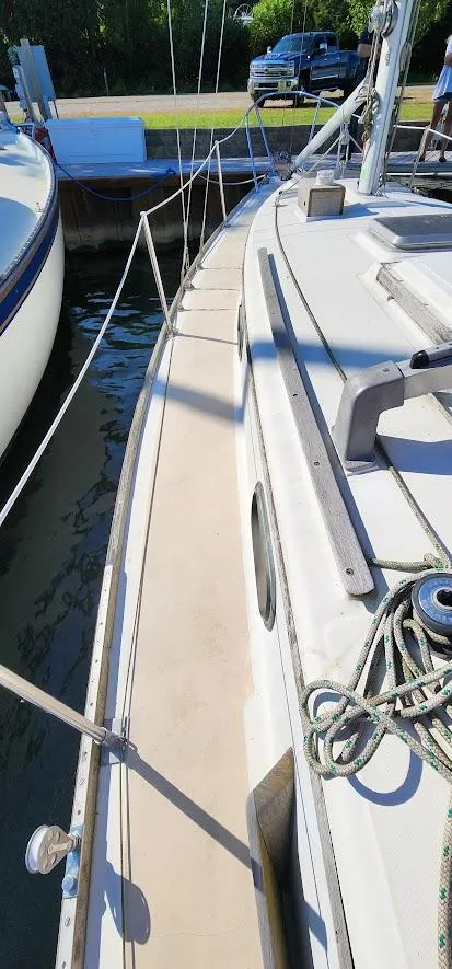 Slide: The Image of 1980 Cape Dory 30 sailboat docked, showing deck and rigging details. - 33