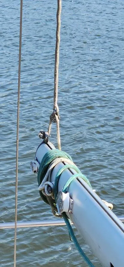 Slide: The Image of Close-up of a 1980 Cape Dory 30 sailboat mast and rigging over water. - 38