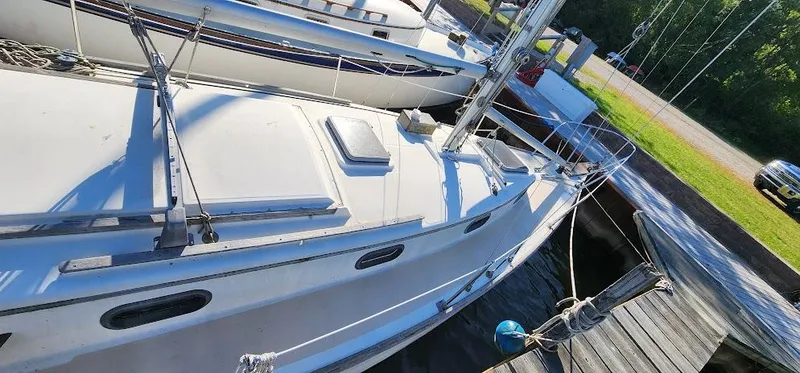 Slide: The Image of 1980 Cape Dory 30 sailboat docked, showing deck and rigging details. - 4