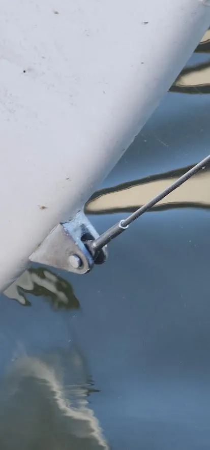 Slide: The Image of Close-up of a 1980 Cape Dory 30 sailboat's rigging and hull near water. - 40