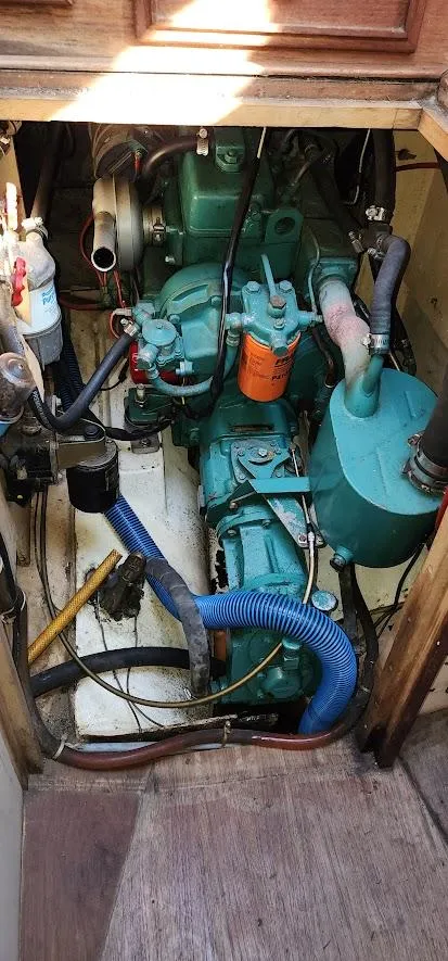 Slide: The Image of Engine compartment of a 1980 Cape Dory 30 sailboat, showcasing mechanical components. - 45