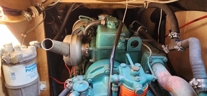 Slide: The Image of Engine compartment of a 1980 Cape Dory 30 sailboat, featuring a diesel engine. - 46