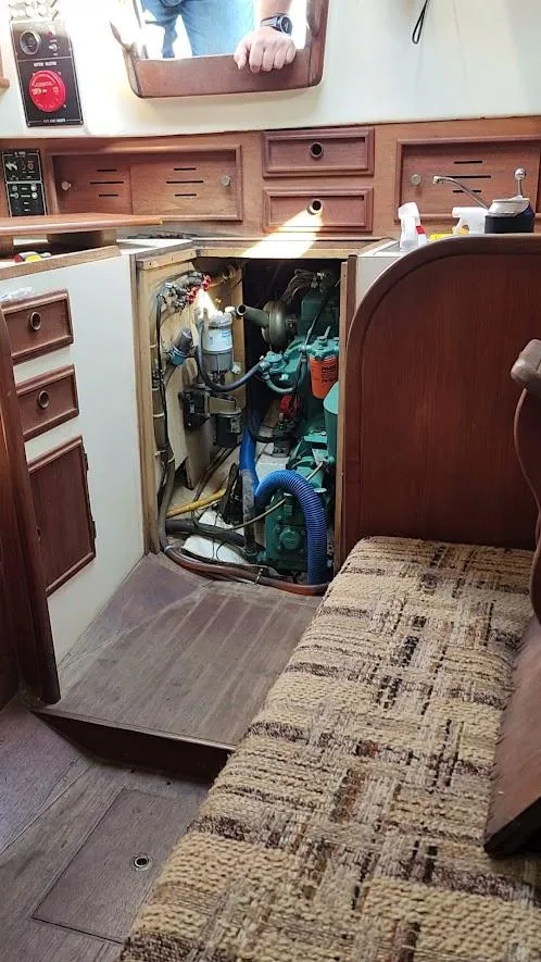 Slide: The Image of Interior of 1980 Cape Dory 30 sailboat showing engine compartment and wooden cabinetry. - 47