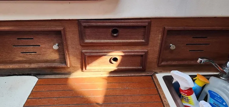 Slide: The Image of Wooden cabinetry and sink area on a 1980 Cape Dory 30 sailboat. - 49