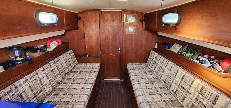 Slide: The Image of Interior of 1980 Cape Dory 30 sailboat with wood paneling and patterned seating. - 5