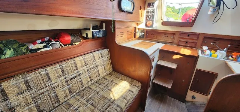 Slide: The Image of 1980 Cape Dory 30 sailboat interior with wood finish, seating, and storage. - 8