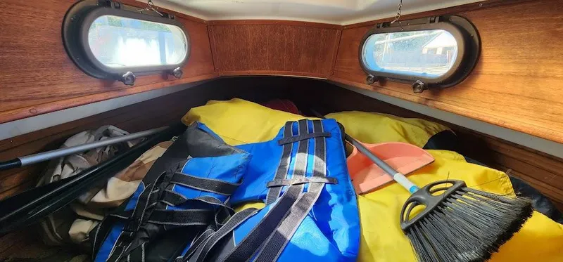 Slide: The Image of Interior of 1980 Cape Dory 30 sailboat with life jackets and cleaning tools. - 9