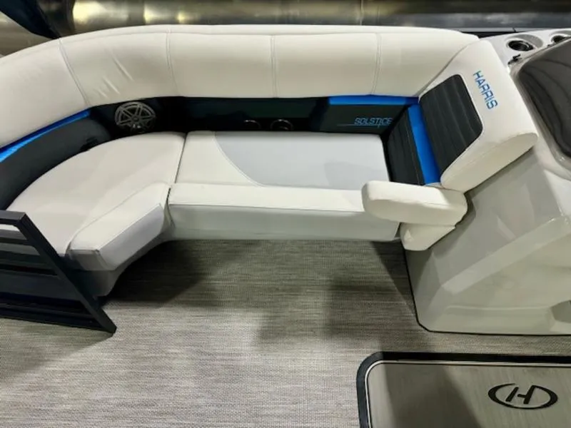 Slide: The Image of 2024 Harris Solstice 230 SLDH boat interior with white seating and blue accents. - 4