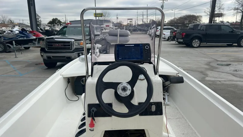 Slide: The Image of 2018 Mako Pro Skiff 17 CC center console with steering wheel and navigation system. - 11