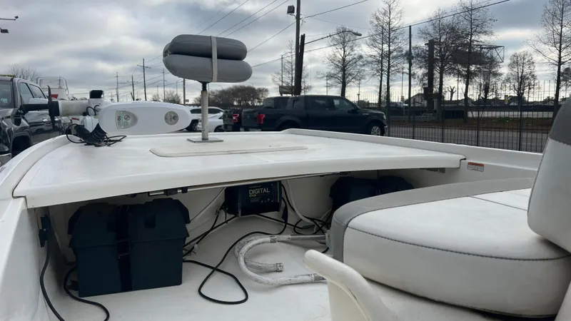 Slide: The Image of 2018 Mako Pro Skiff 17 CC boat interior with seating and storage compartments. - 12