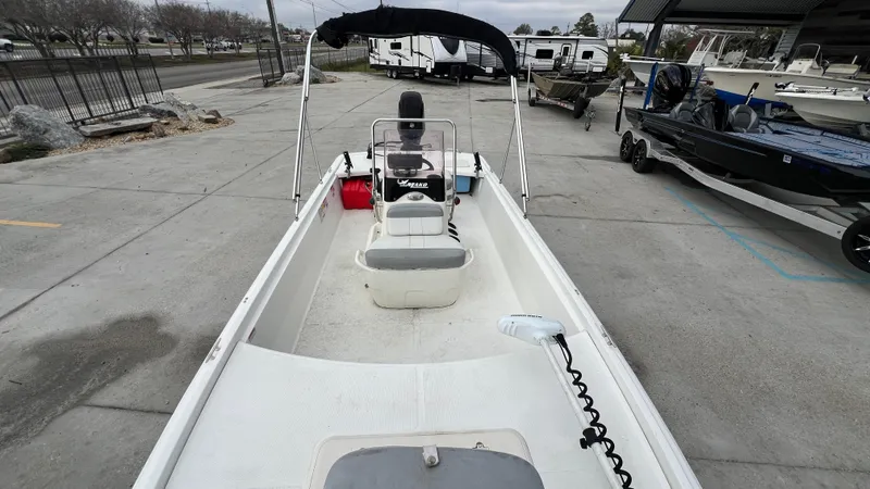 Slide: The Image of 2018 Mako Pro Skiff 17 CC boat, center console, docked in a marina. - 13