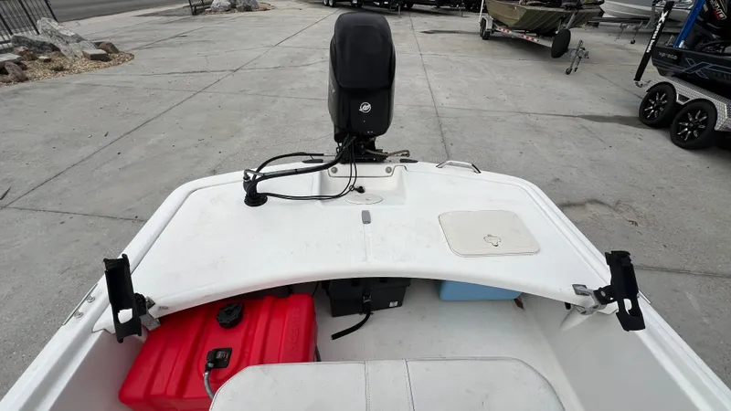 Slide: The Image of 2018 Mako Pro Skiff 17 CC boat with outboard motor and storage compartments. - 16