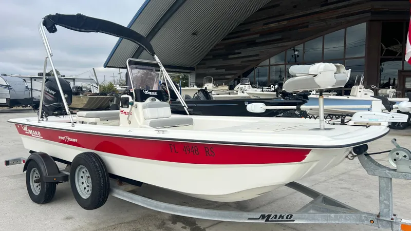Slide: The Image of 2018 Mako Pro Skiff 17 CC on trailer, red and white, side view. - 4