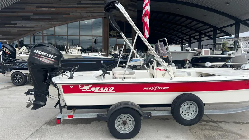 Slide: The Image of 2018 Mako Pro Skiff 17 CC boat on trailer with Mercury outboard motor. - 5