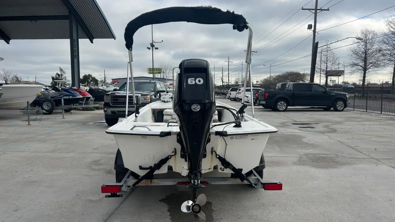 Slide: The Image of 2018 Mako Pro Skiff 17 CC with 60 HP engine, rear view in a parking lot. - 6