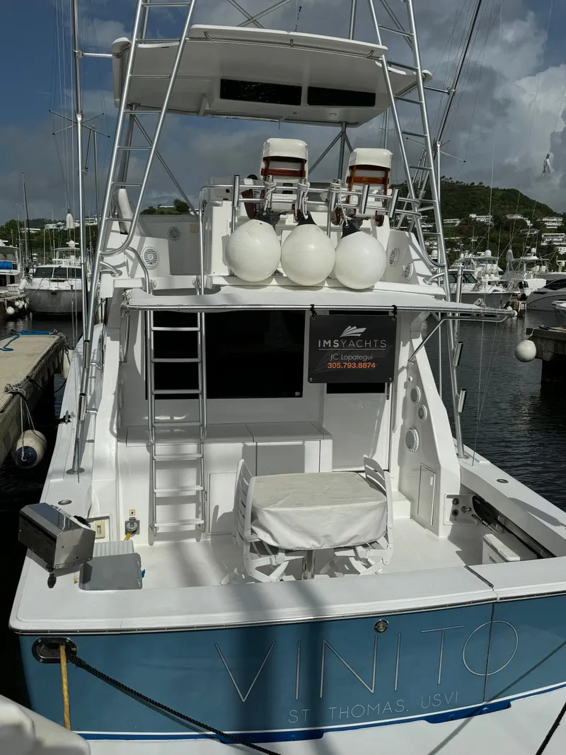 Slide: The Image of 1997 Viking 43 Convertible yacht docked at marina, rear view with fishing chairs. - 13
