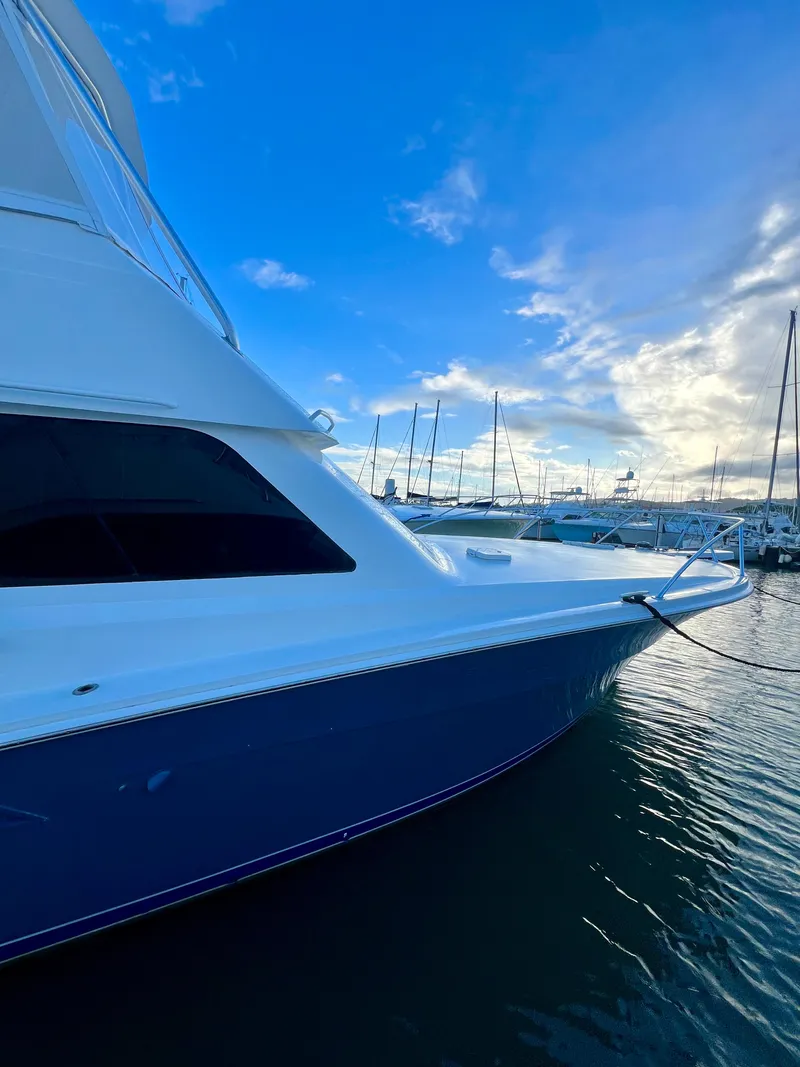 Slide: The Image of 1997 Viking 43 Convertible yacht docked at marina under blue sky. - 20