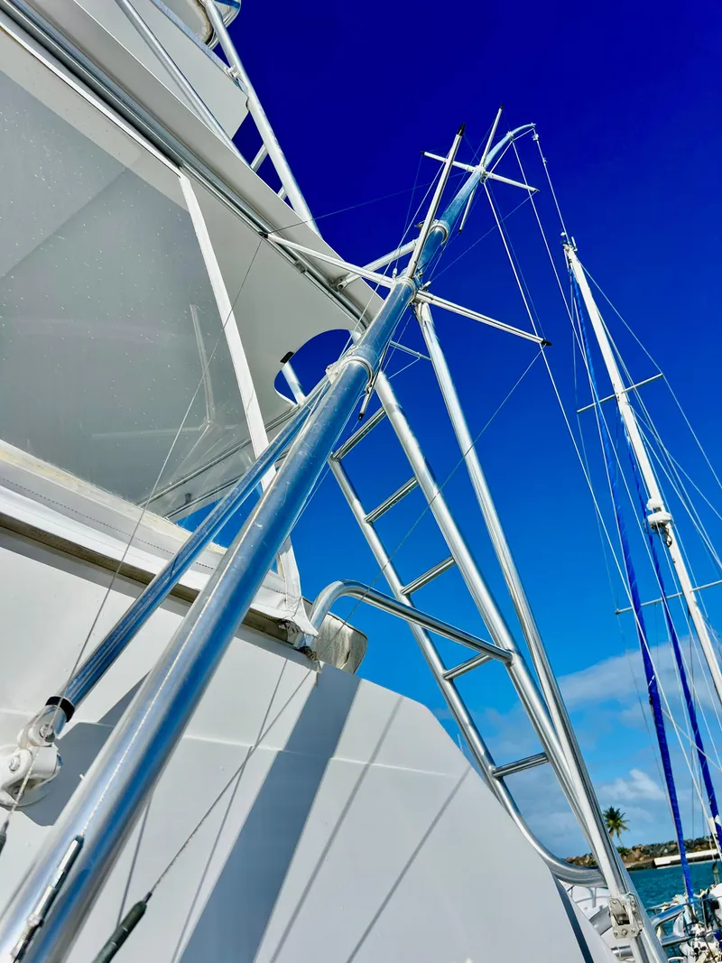 Slide: The Image of Close-up of a 1997 Viking 43 Convertible yacht's ladder and rigging against a clear blue sky. - 25