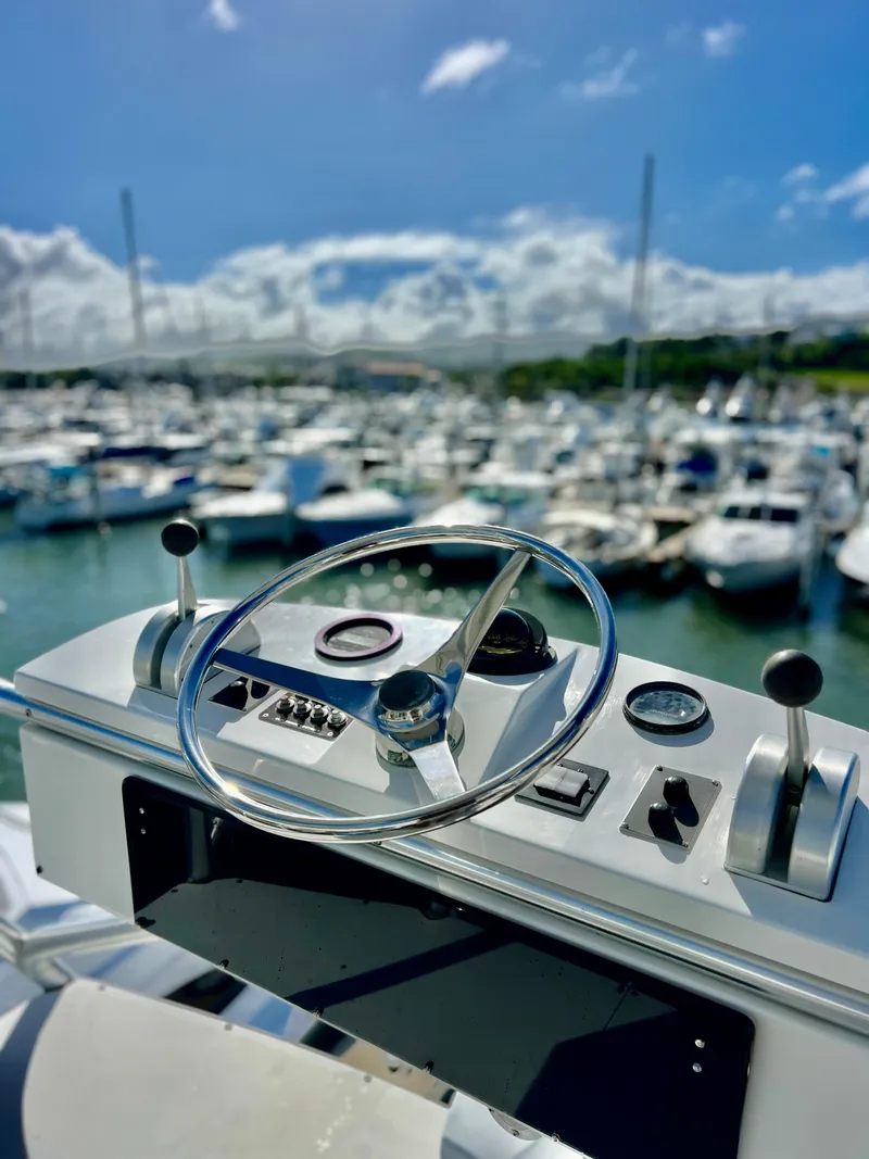 Slide: The Image of Helm of 1997 Viking 43 Convertible yacht with marina in background. - 30