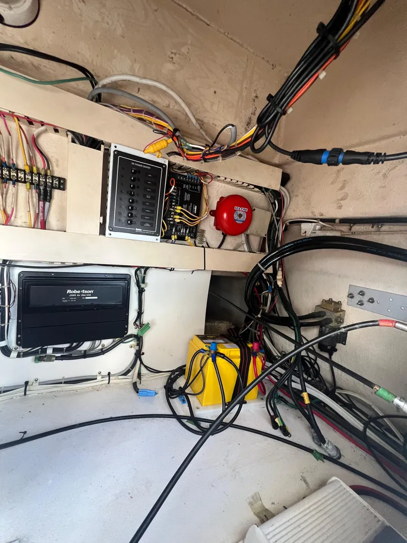 Slide: The Image of Electrical wiring and components inside a 1997 Viking 43 Convertible boat. - 34