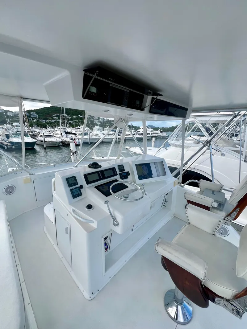 Slide: The Image of Helm station of a 1997 Viking 43 Convertible yacht in a marina. - 36