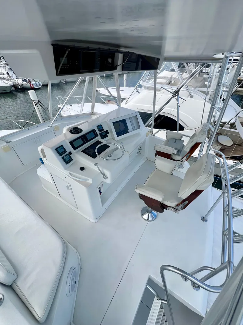 Slide: The Image of 1997 Viking 43 Convertible yacht helm station with navigation equipment and captain's chairs. - 37
