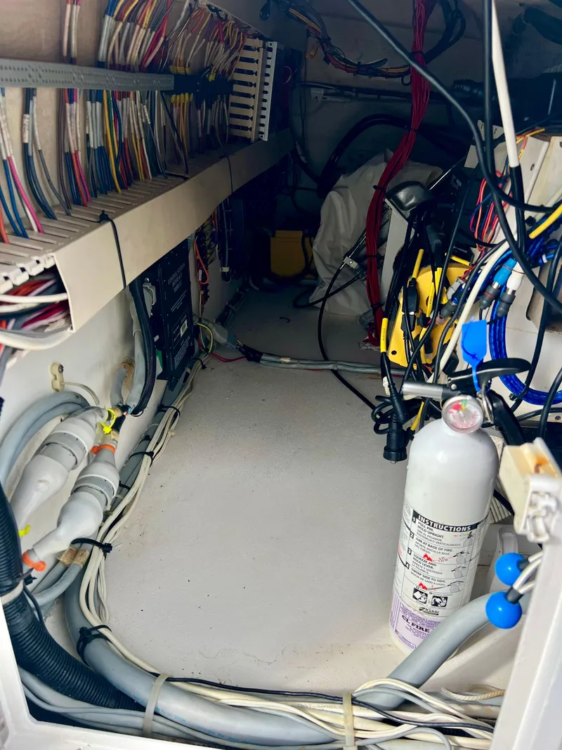 Slide: The Image of Electrical wiring and fire extinguisher in the engine room of a 1997 Viking 43 Convertible boat. - 38