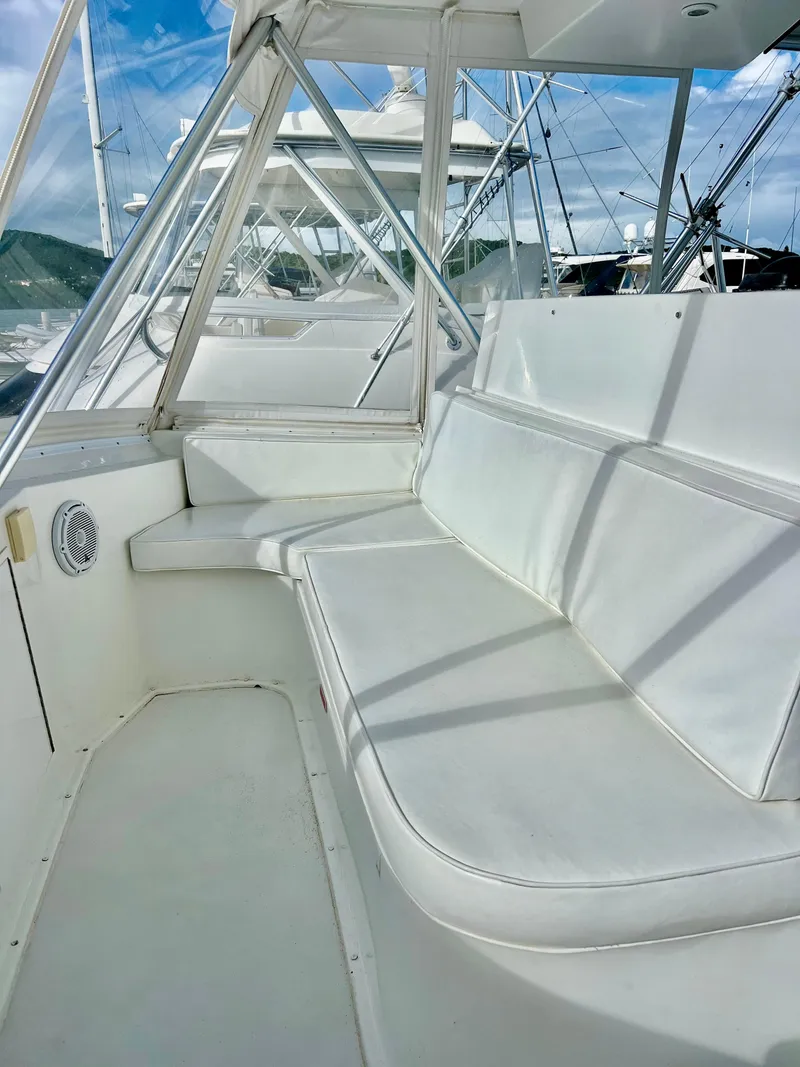 Slide: The Image of Interior seating area of a 1997 Viking 43 Convertible yacht with white cushions. - 39