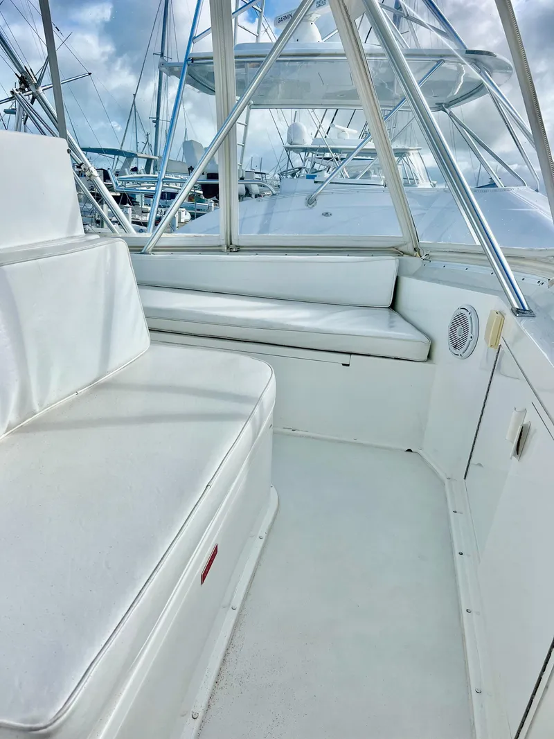 Slide: The Image of Interior seating area of a 1997 Viking 43 Convertible yacht with white cushions. - 40