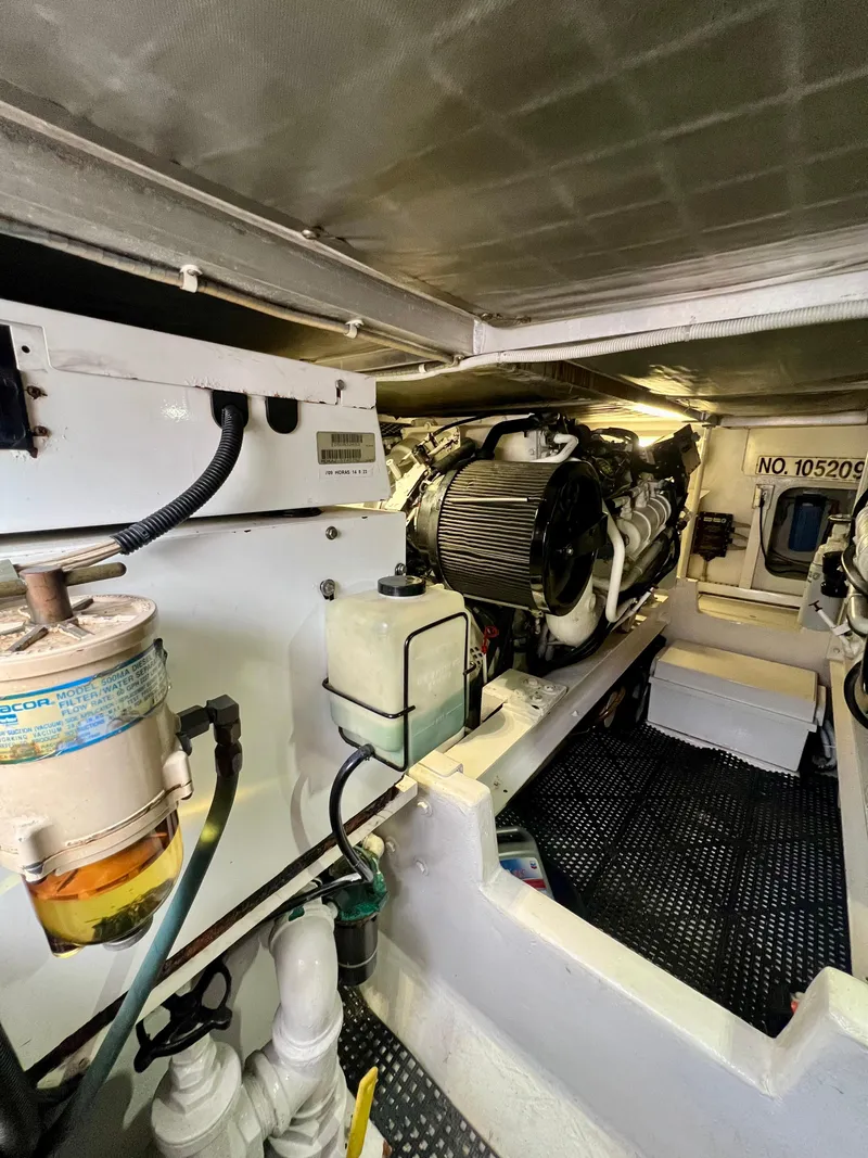 Slide: The Image of Engine room of a 1997 Viking 43 Convertible yacht, showcasing mechanical components. - 46