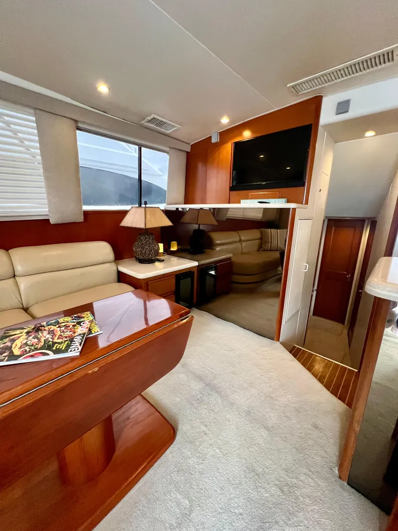 Slide: The Image of Interior of 1997 Viking 43 Convertible yacht with cozy seating and wooden table. - 55